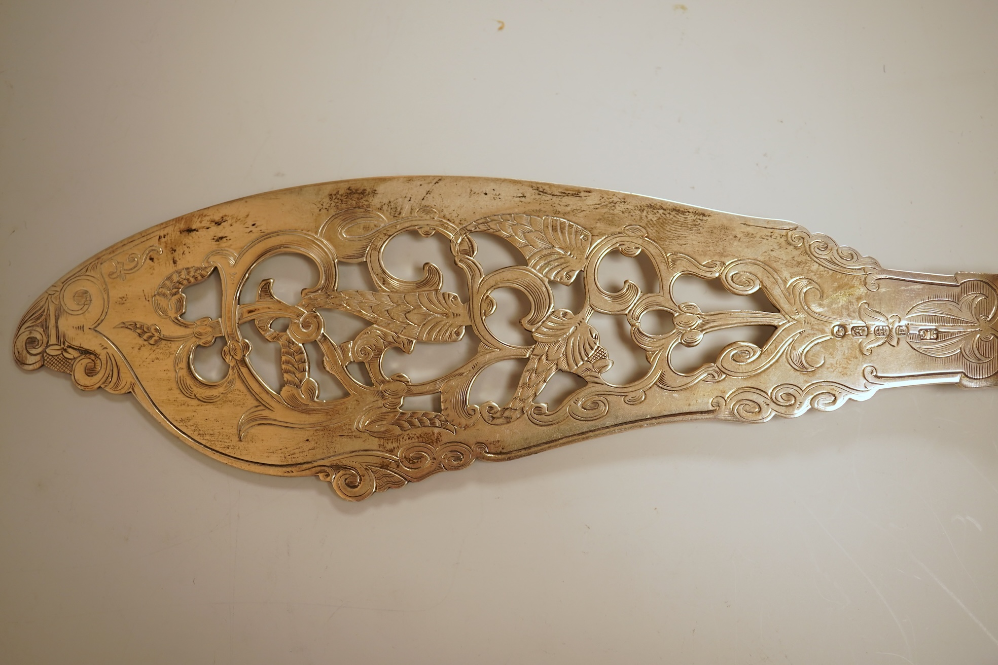 A pair of Victorian ornate silver fish servers, by John Gilbert, Birmingham, 1864, 34.1cm.